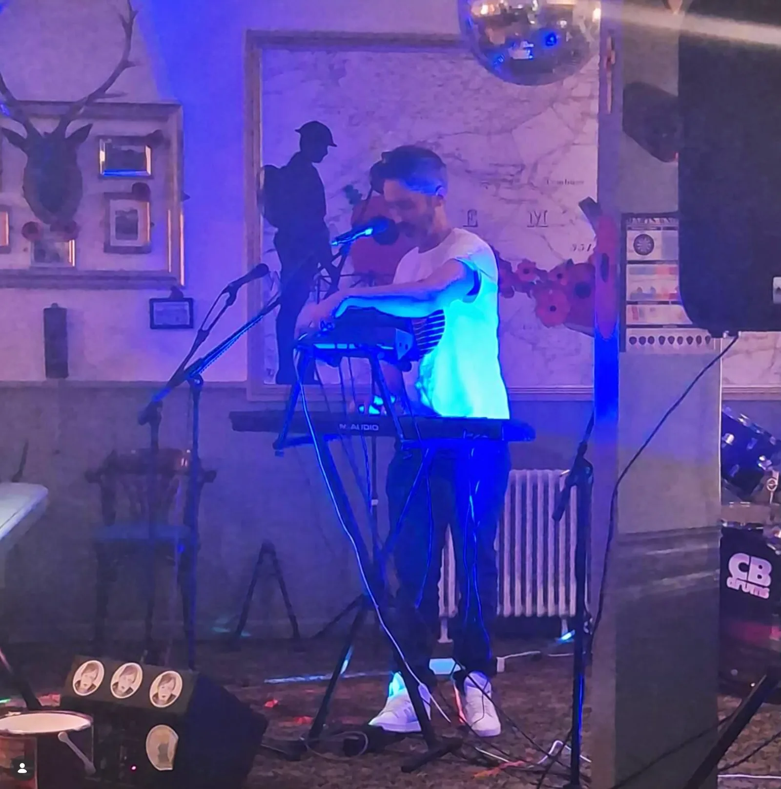 The Girl From Tomorrow performing under blue stage light